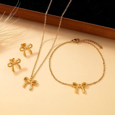 Set dorado aretes, pulsera y collar moñitas